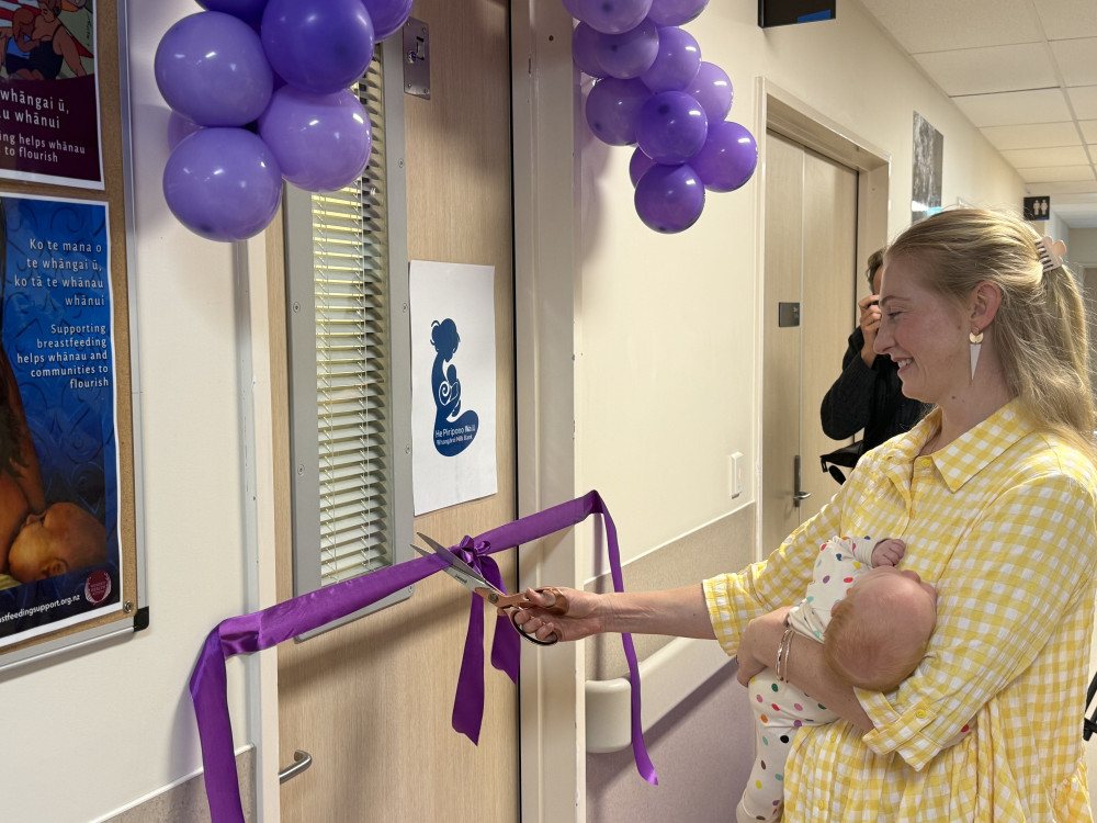 Ashlee Robinson cuts the ribbon