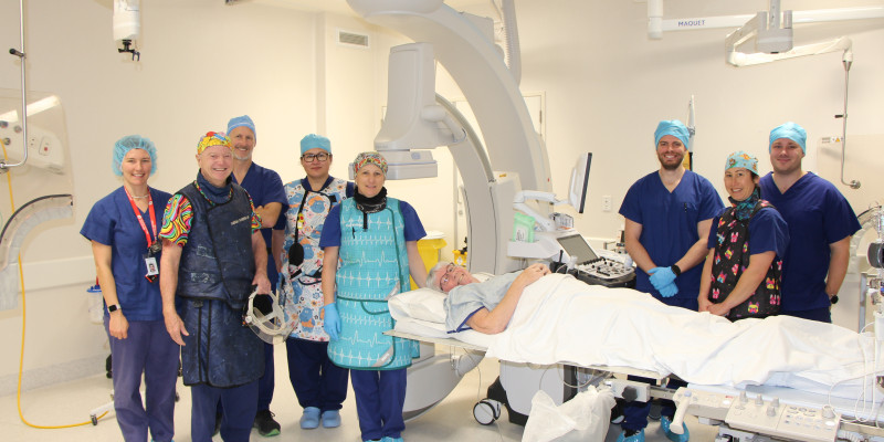 Doctors around a patient in an angiogram machine