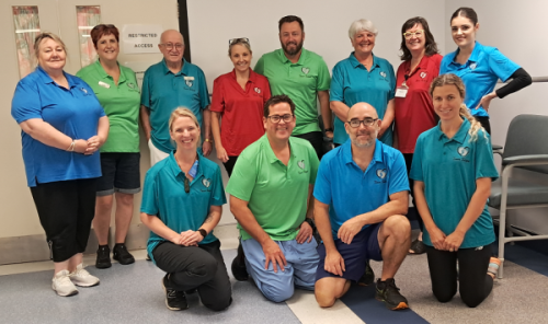 group photo of tailpes staff at Northland wearing bringht shirts